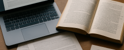 An annotated English novel and research notes sit beside a laptop showing text analysis